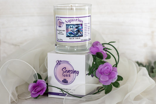 Candle with Aquarius label and Sensing Spirit packaging on a white background