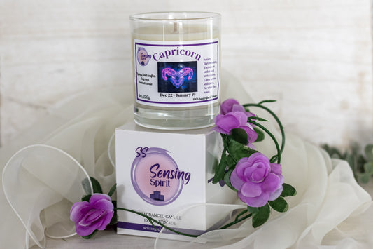 Capricorn candle and packaging with purple flowers on a white background